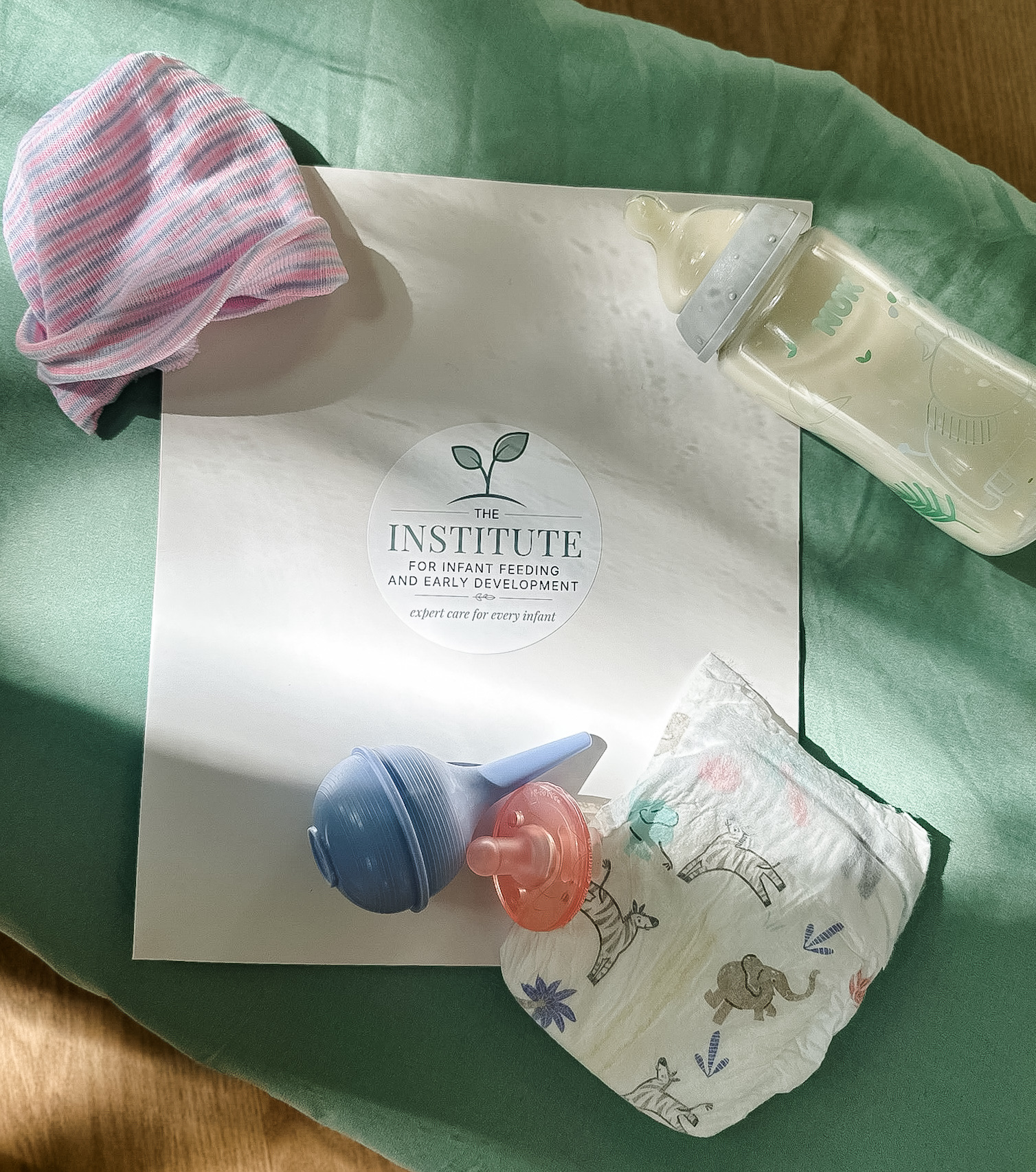The Institute for Infant Feeding and Early Development logo with baby supplies