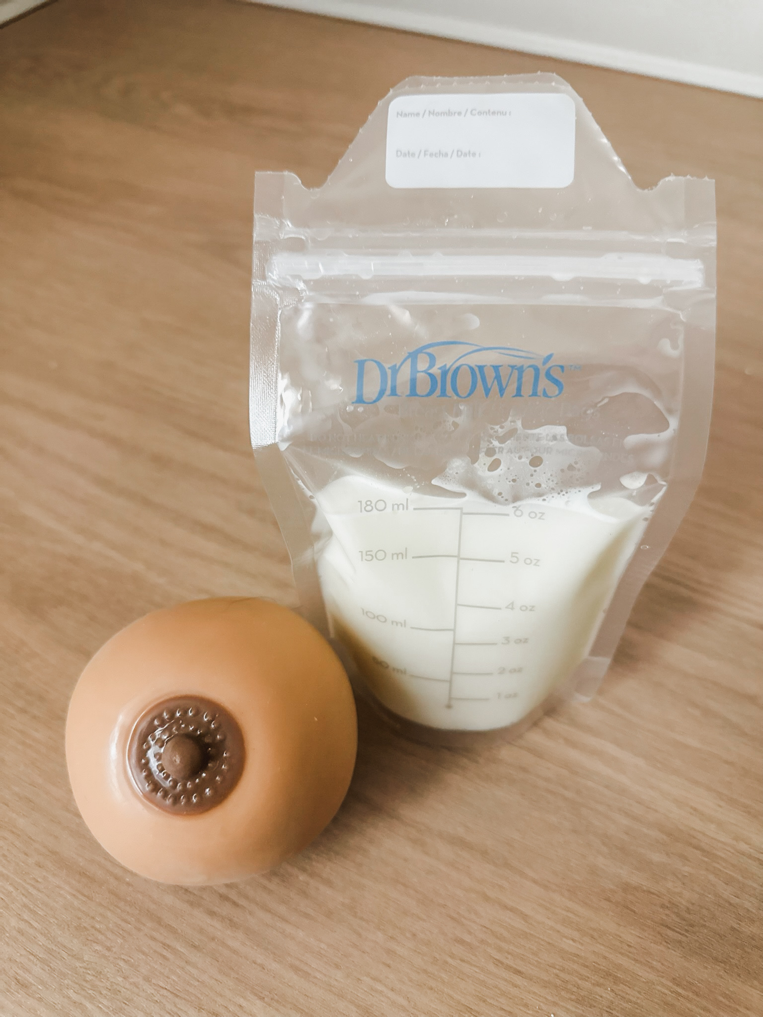 A simulated breast feeding setup with a filled milk storage bag
