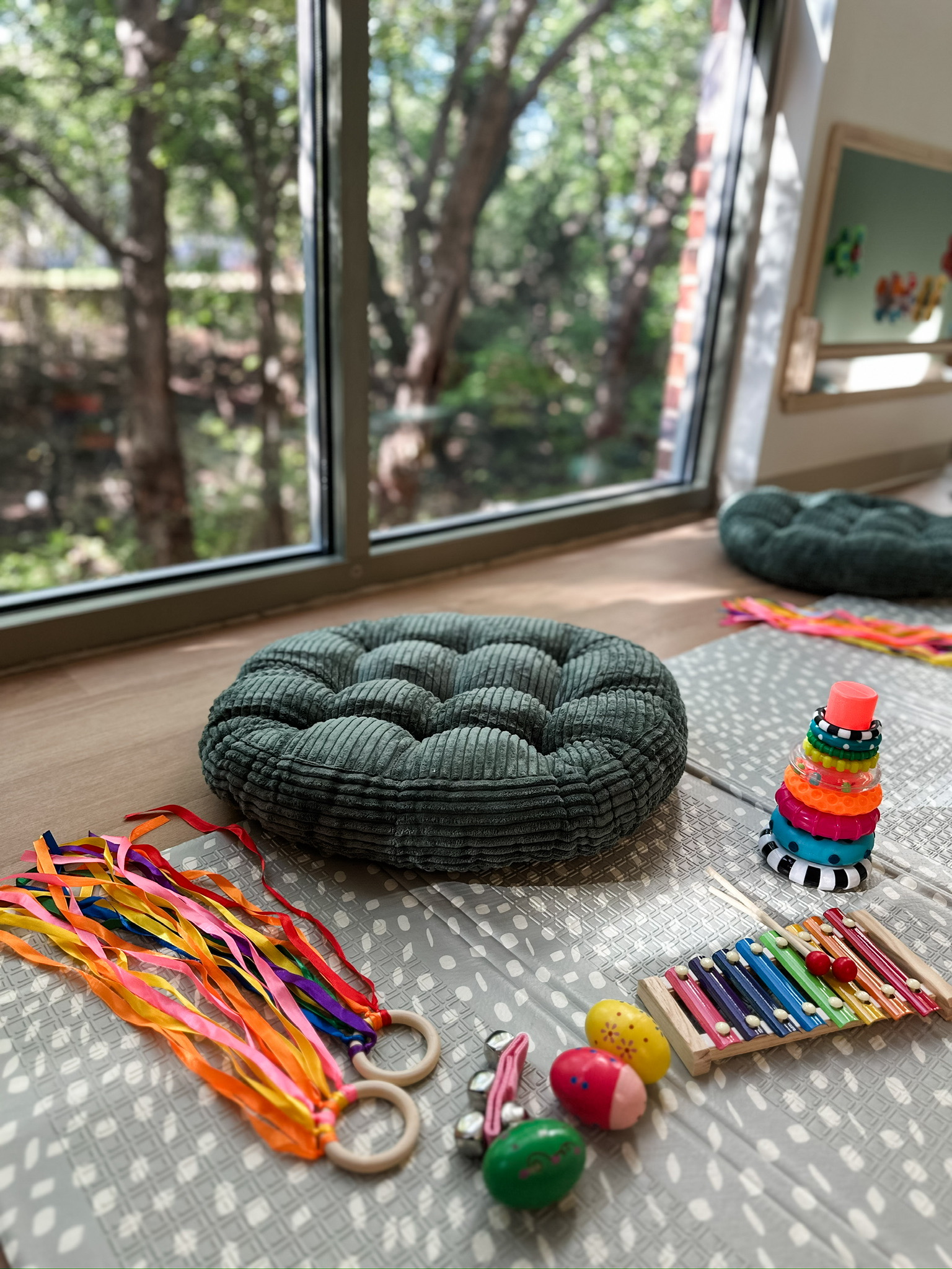 Mat with infant supplies overlooking wooded creek