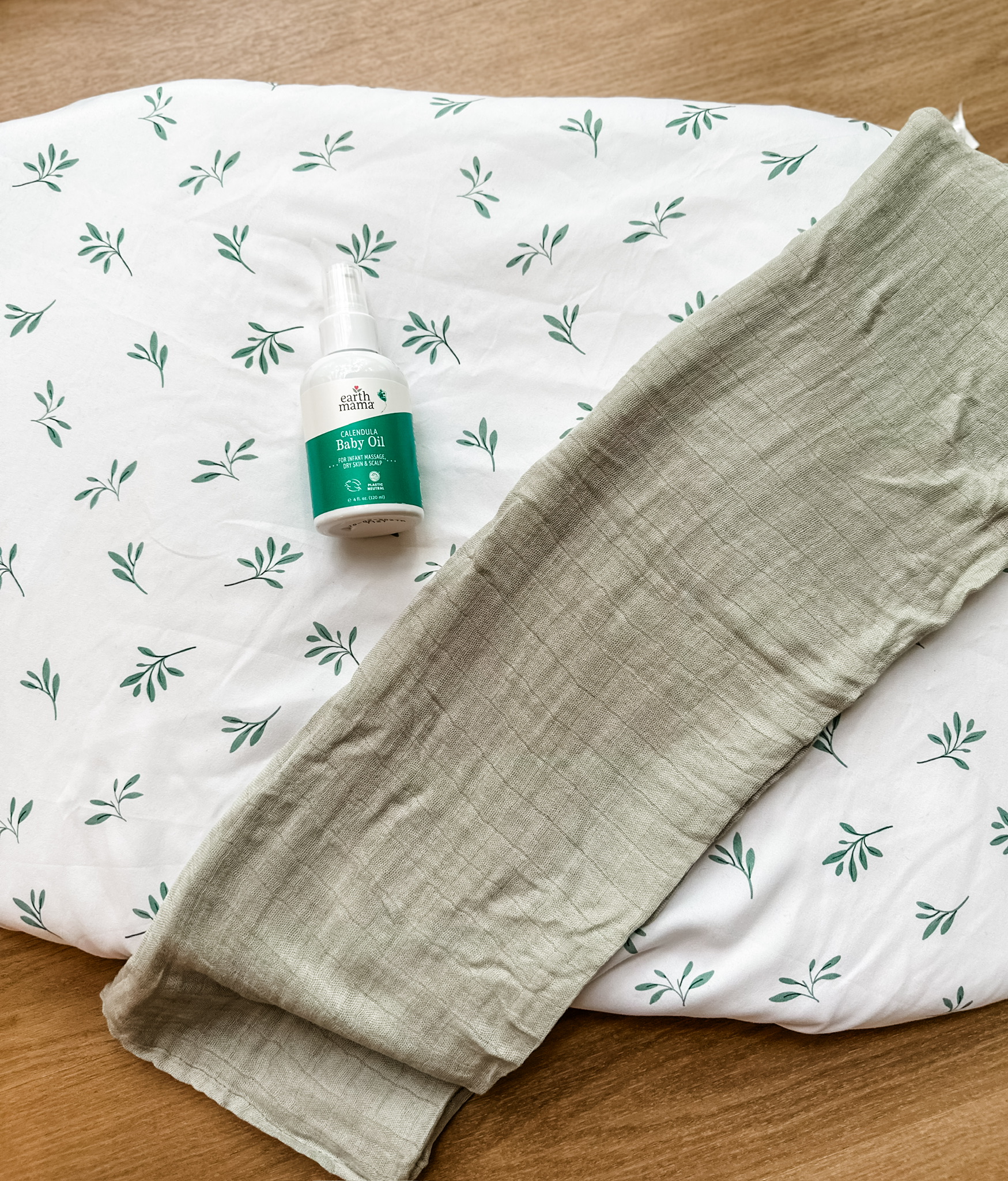Infant massage oil on a muslin mat