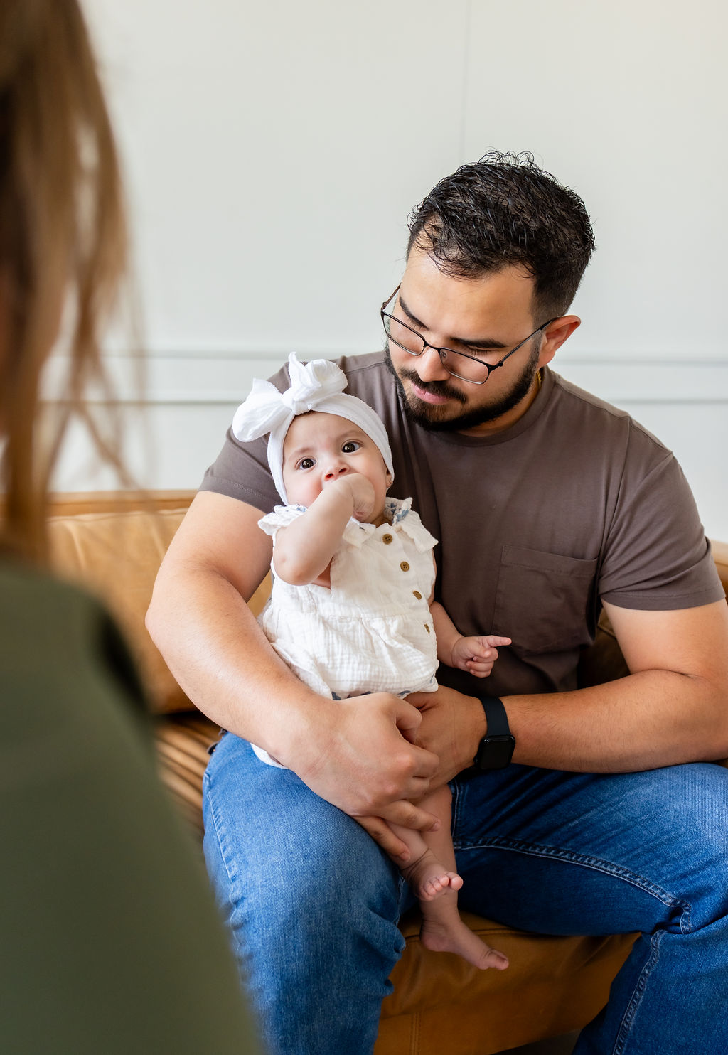 An Institute clinician smiling while holding an infant